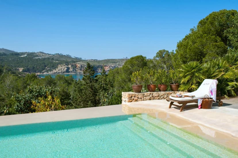 Surrounded by 30 acres of lush pine forest and its own secluded beach cove only a stone's throw away