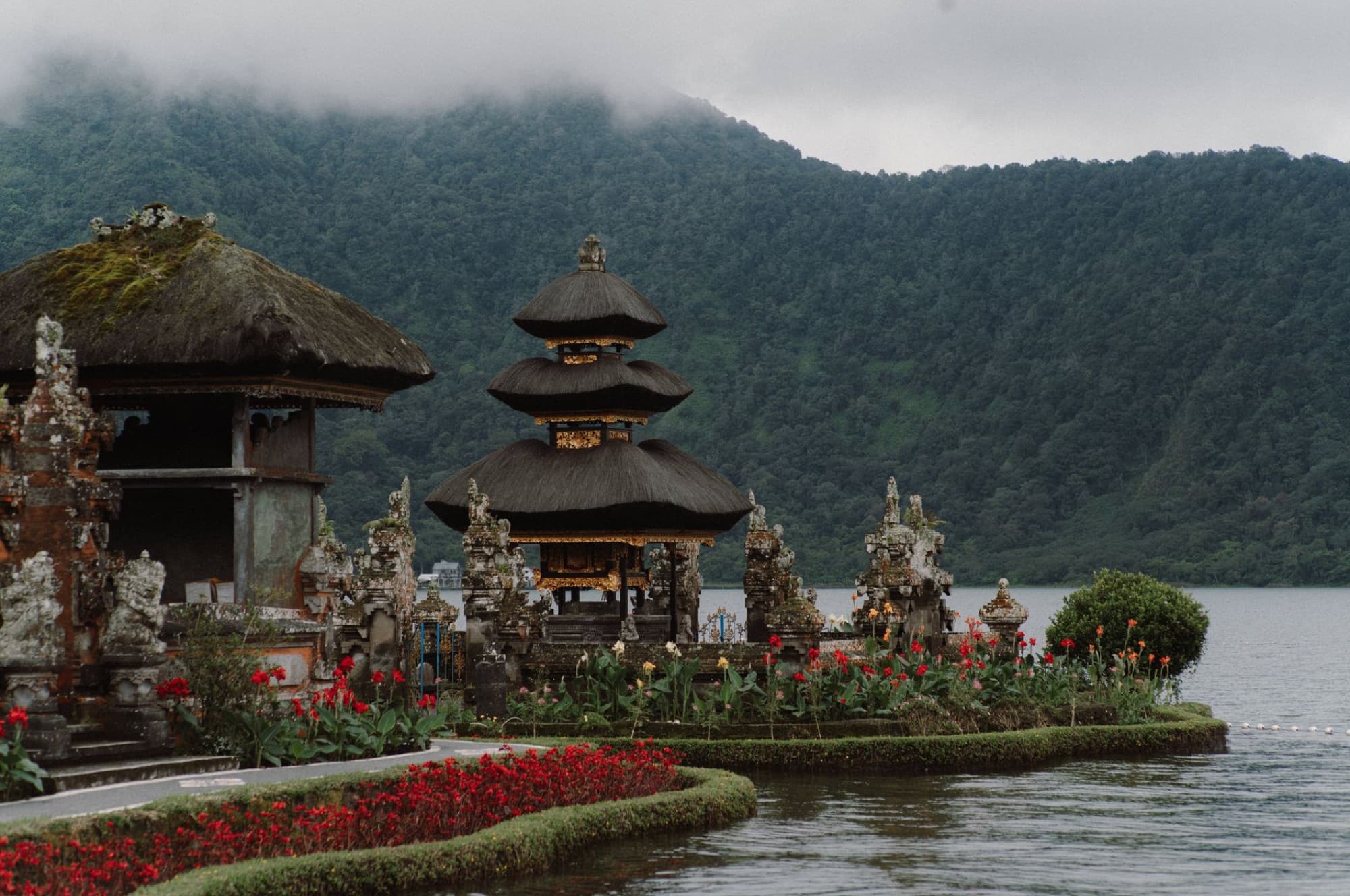 Breathtaking landscape of Ulun Danu Beratan Temple with lake and mountains in Bali.