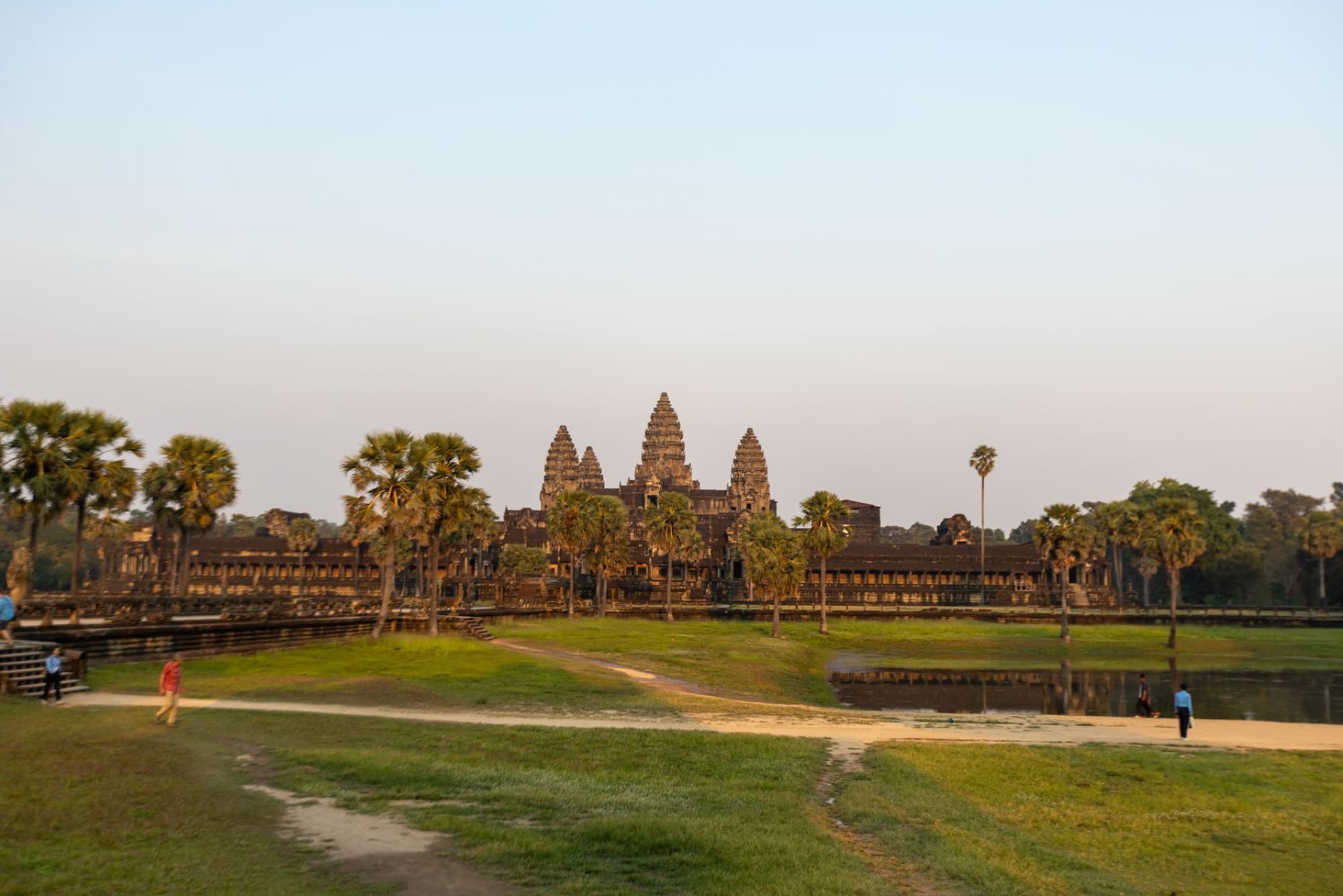 A scenic view of Angkor Wat in Cambodia during sunset, showcasing its ancient architecture.