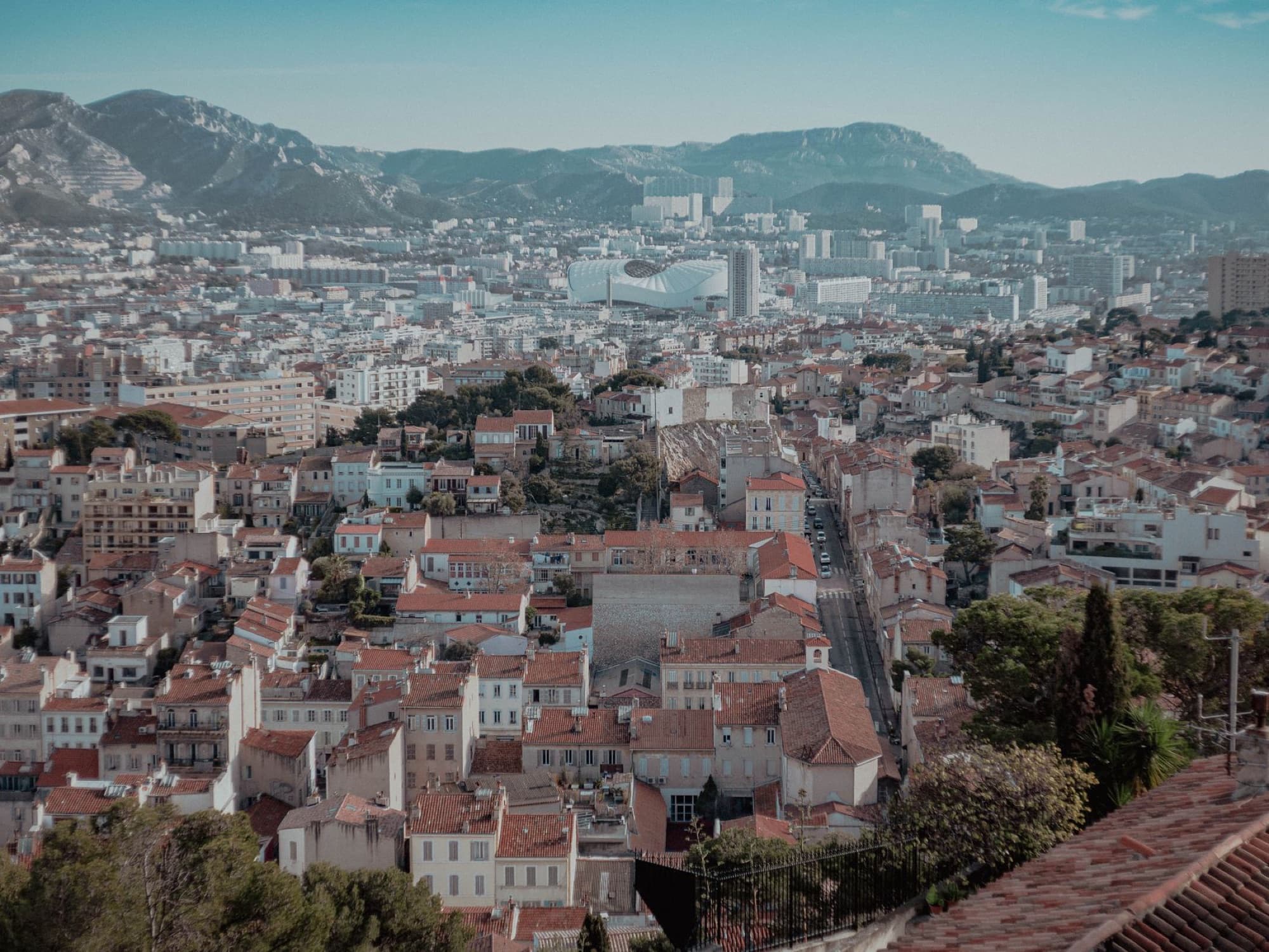 Stunning aerial view of Marseille's urban landscape from above, showcasing iconic architecture.