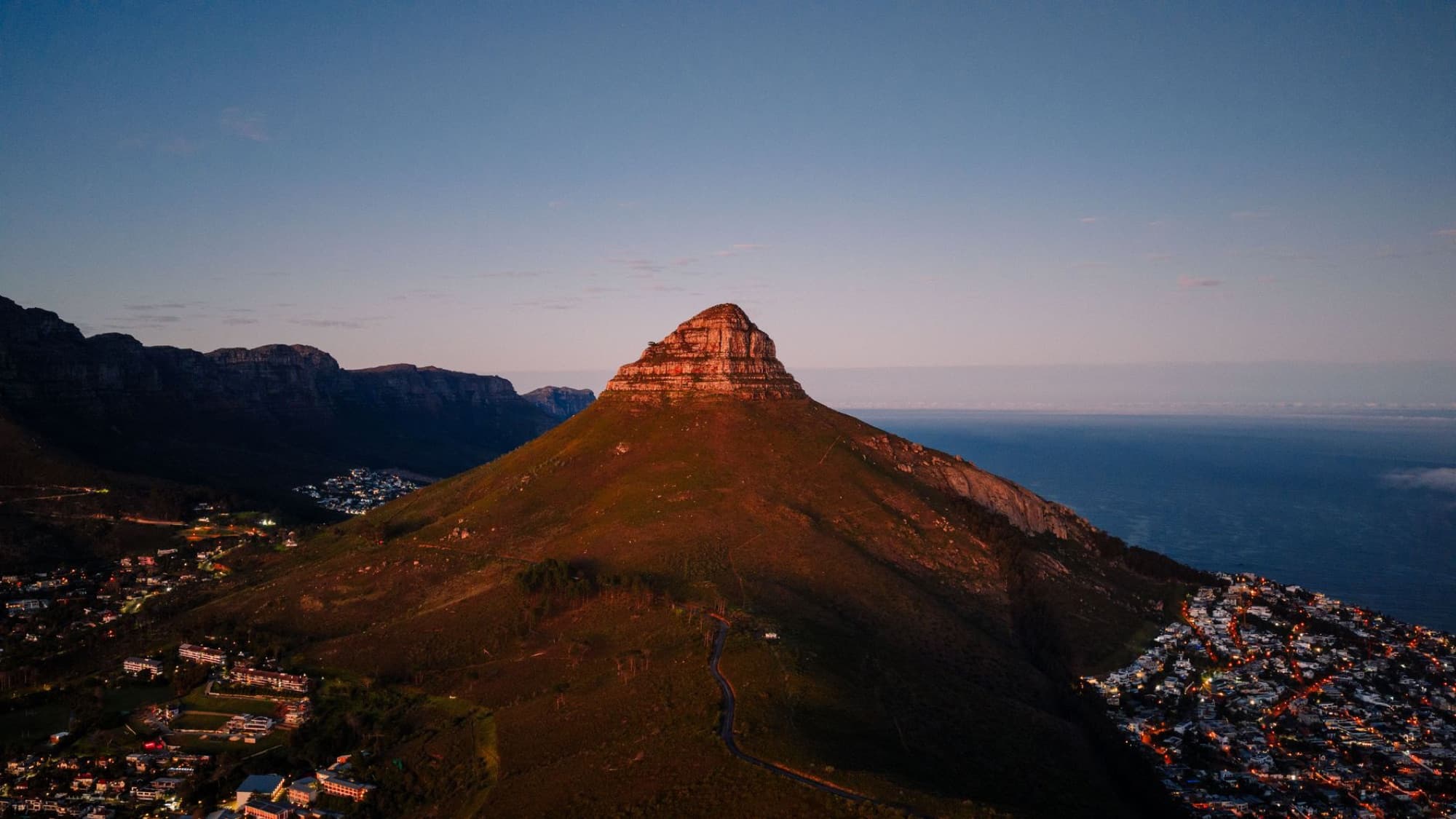 A breathtaking aerial view of Lion's Head mountain during sunset in Cape Town, showcasing nature's beauty.