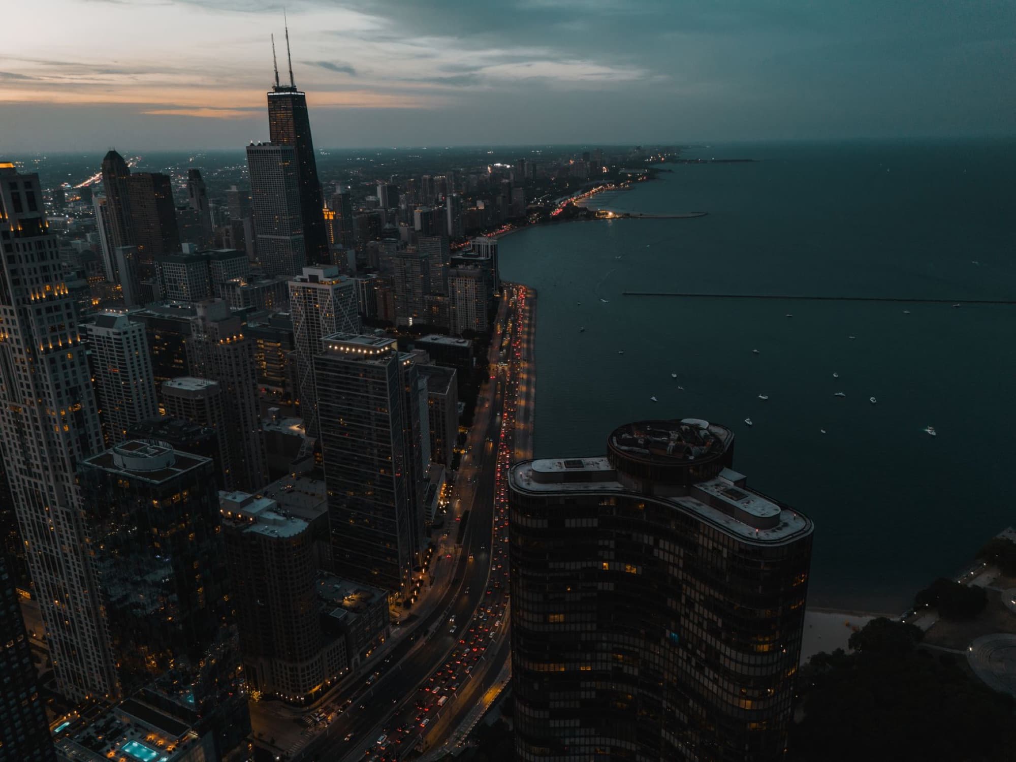 A stunning aerial view of Chicago's skyline and Lake Michigan during twilight, showcasing the city's architecture.
