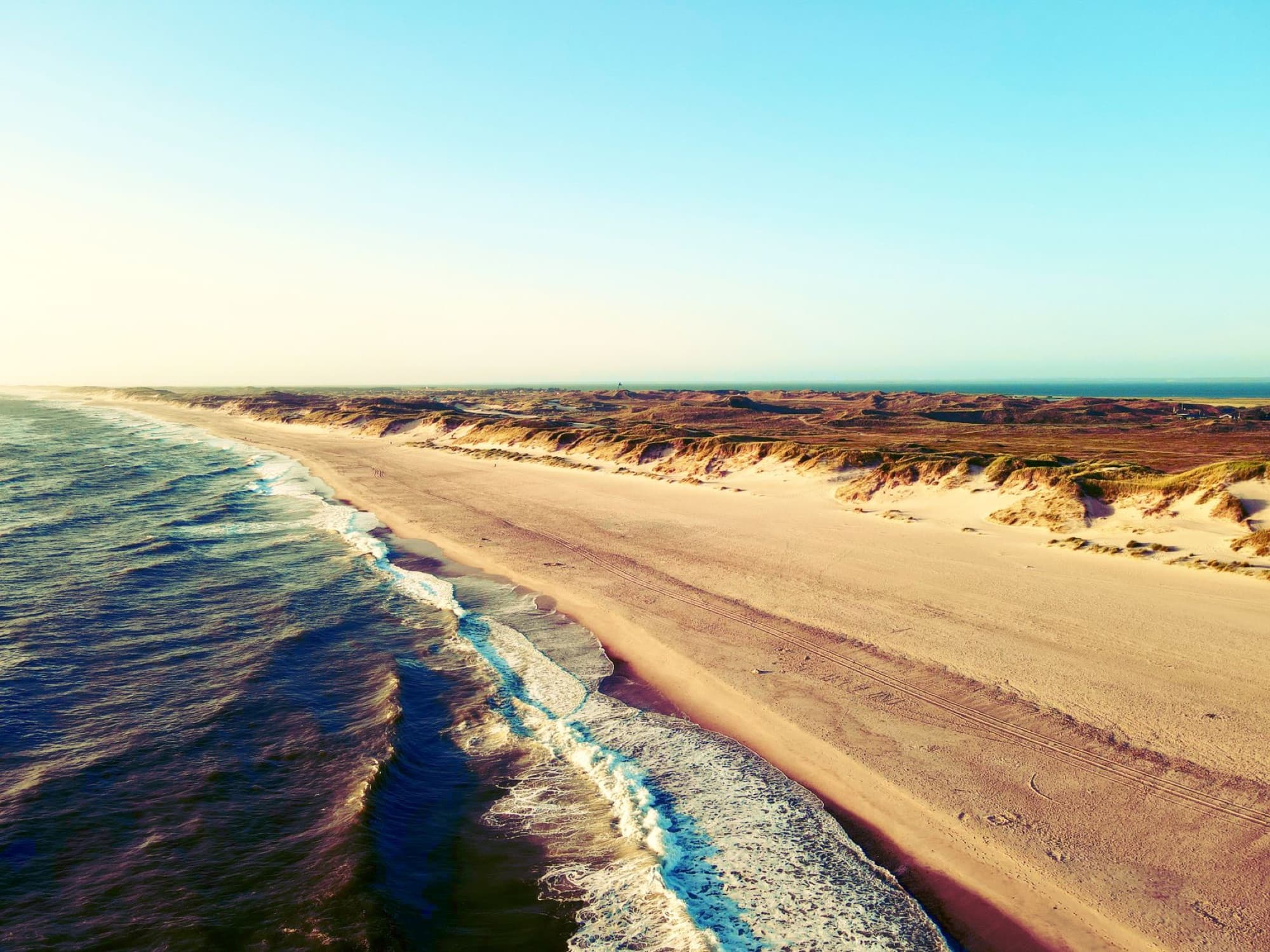 Aerial view of the beach and dunes at Hvide Sande, Denmark. Serene coastal landscape.