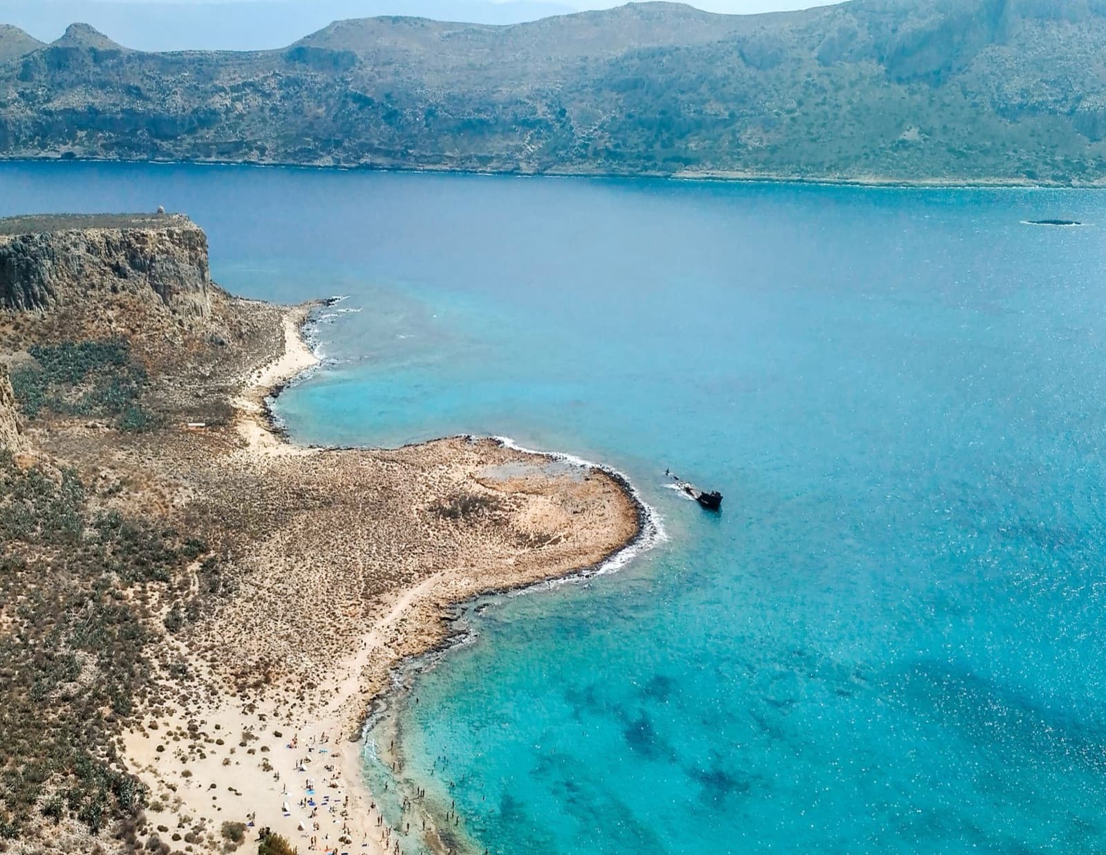 Explore the azure waters and rugged coastline of Balos Beach, Crete from above.