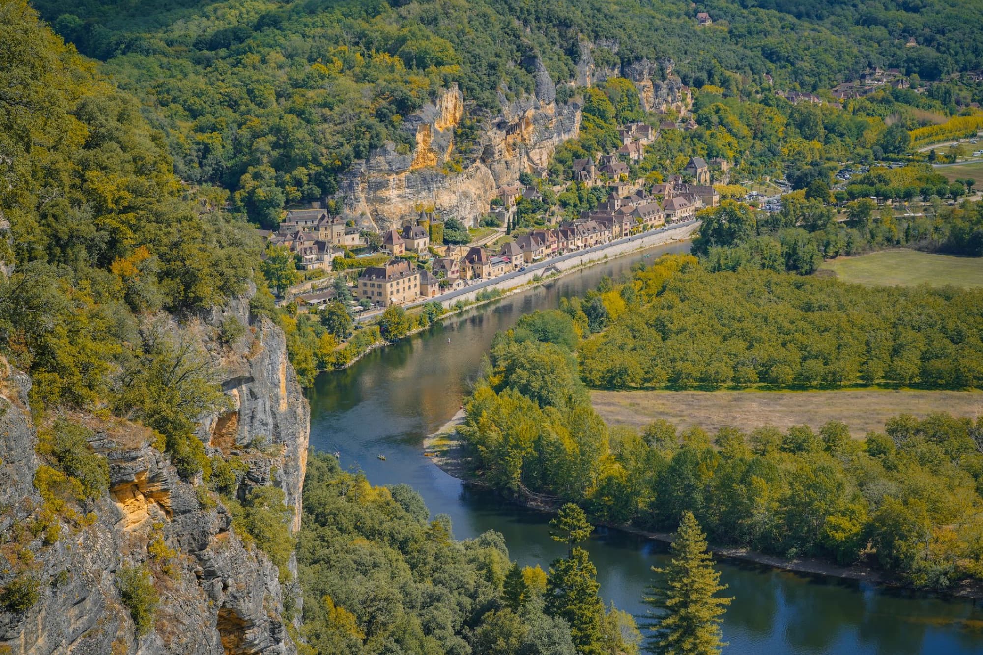A breathtaking aerial view of the Dordogne Valley showcasing lush greenery and a winding river.