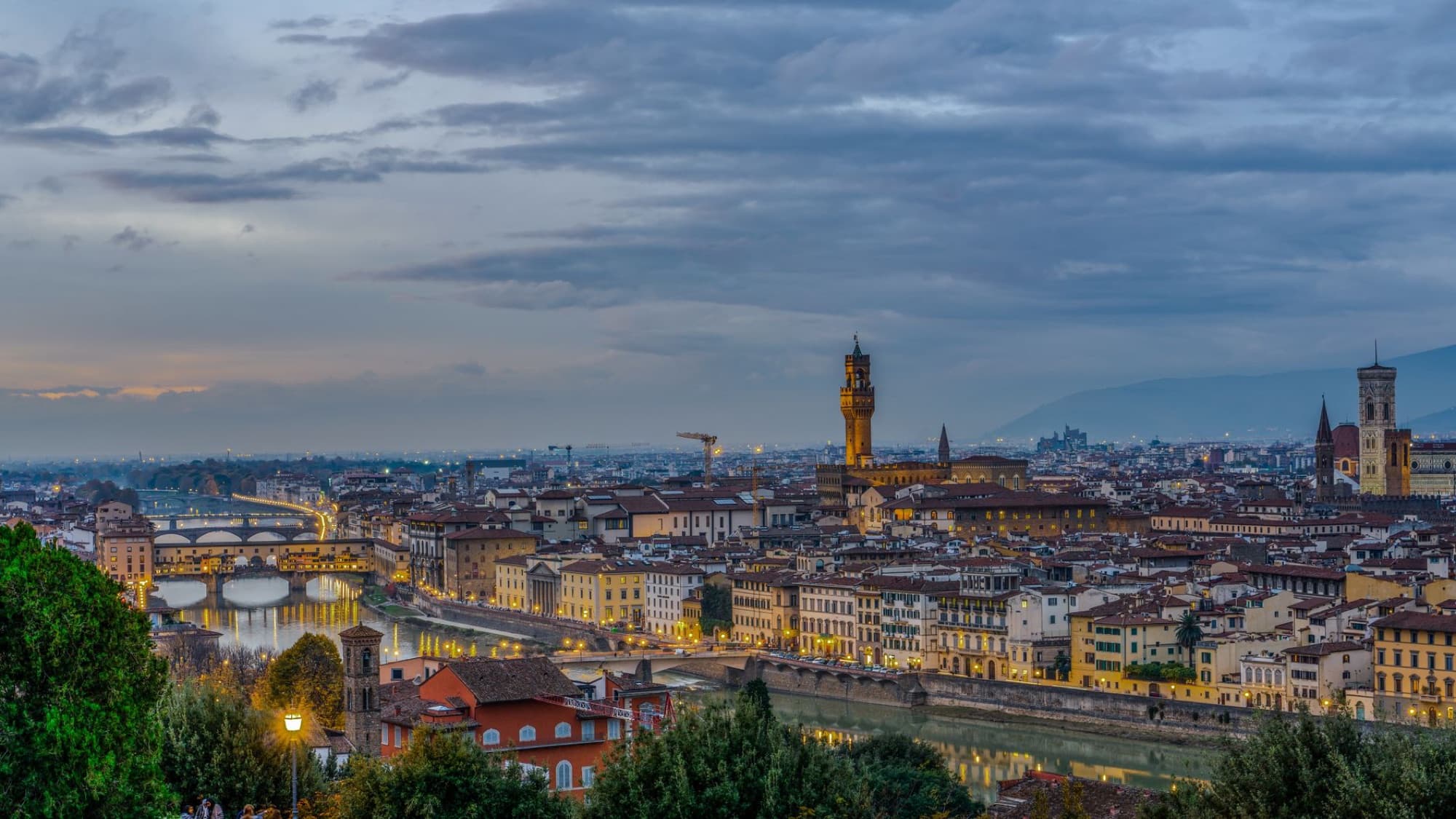 Beautiful aerial twilight view of Florence with the iconic Ponte Vecchio and the Arno River.