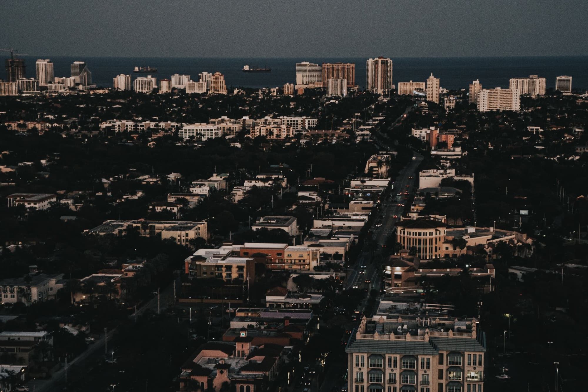 Stunning aerial cityscape of Fort Lauderdale, highlighting the urban skyline and ocean view during twilight.