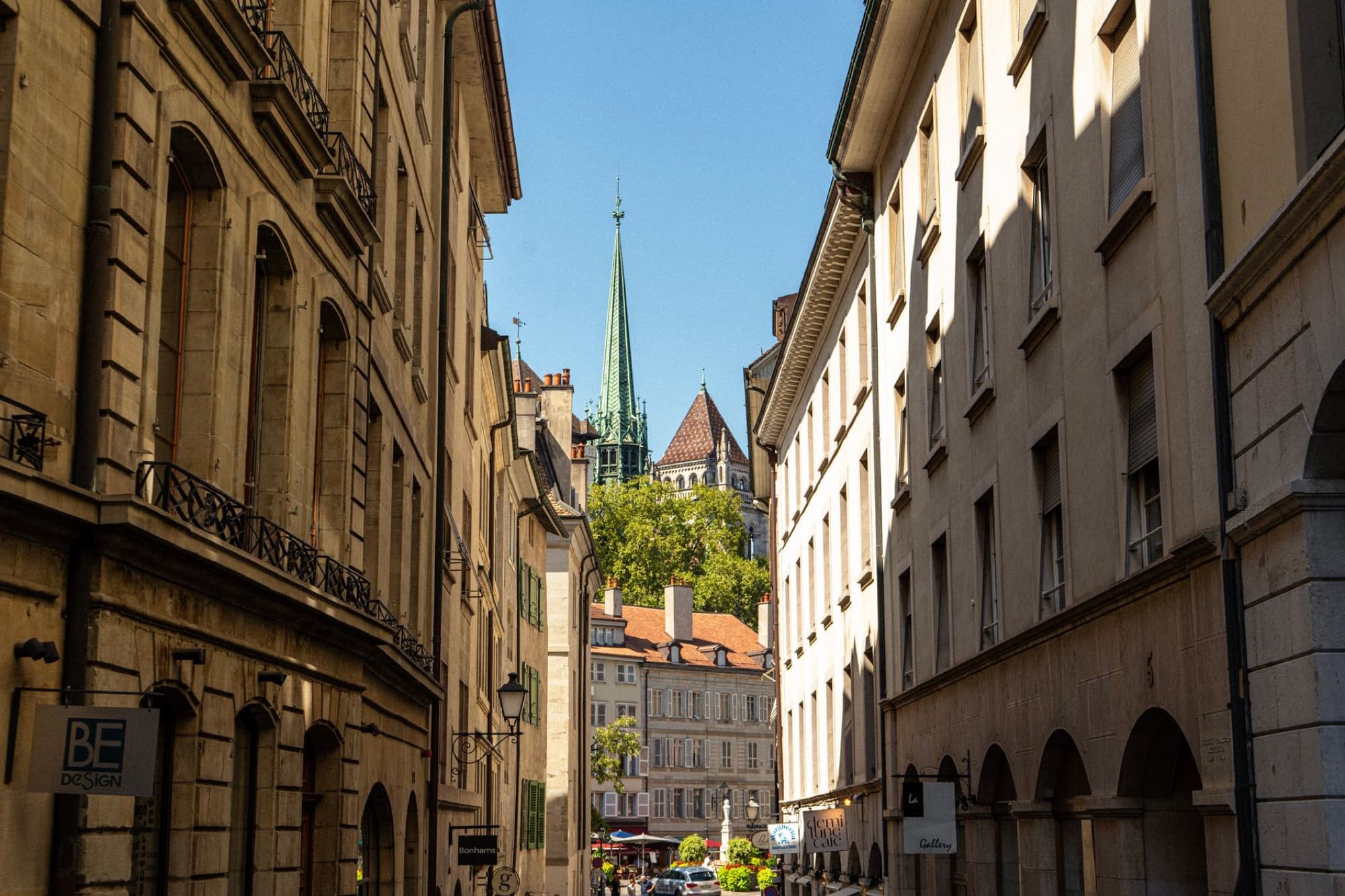 A scenic view of Geneva's historic Old Town, featuring classic architecture and St. Pierre Cathedral's spire.