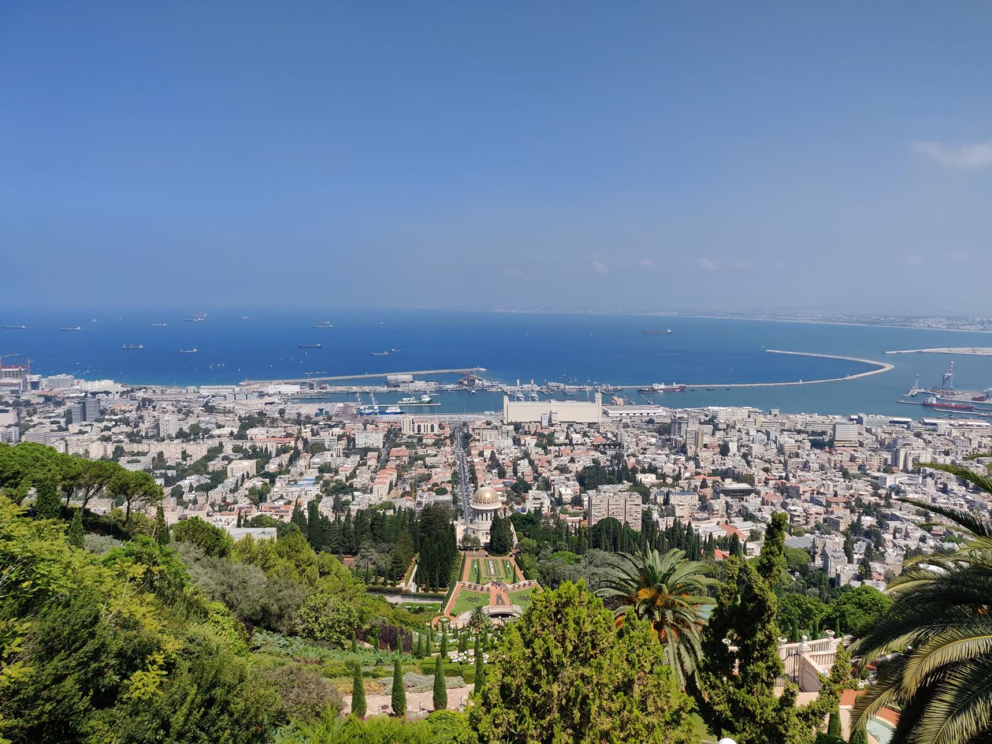 Stunning aerial view of Haifa, Israel, featuring the Baha'i Gardens and the Mediterranean Sea.