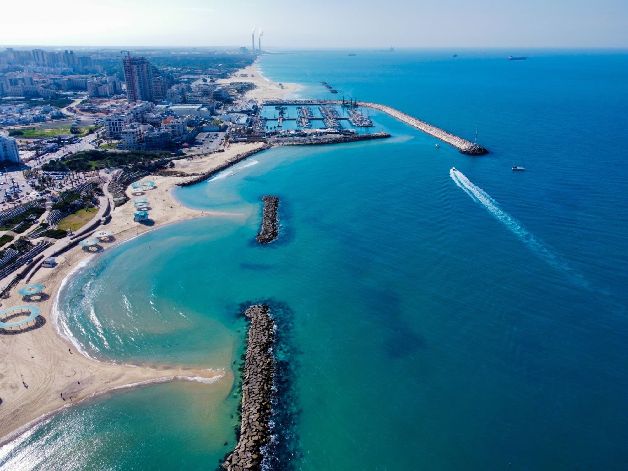 Stunning aerial view of Ashkelon beach and city, Israel. Clear blue sea, sandy shores, and urban skyline.