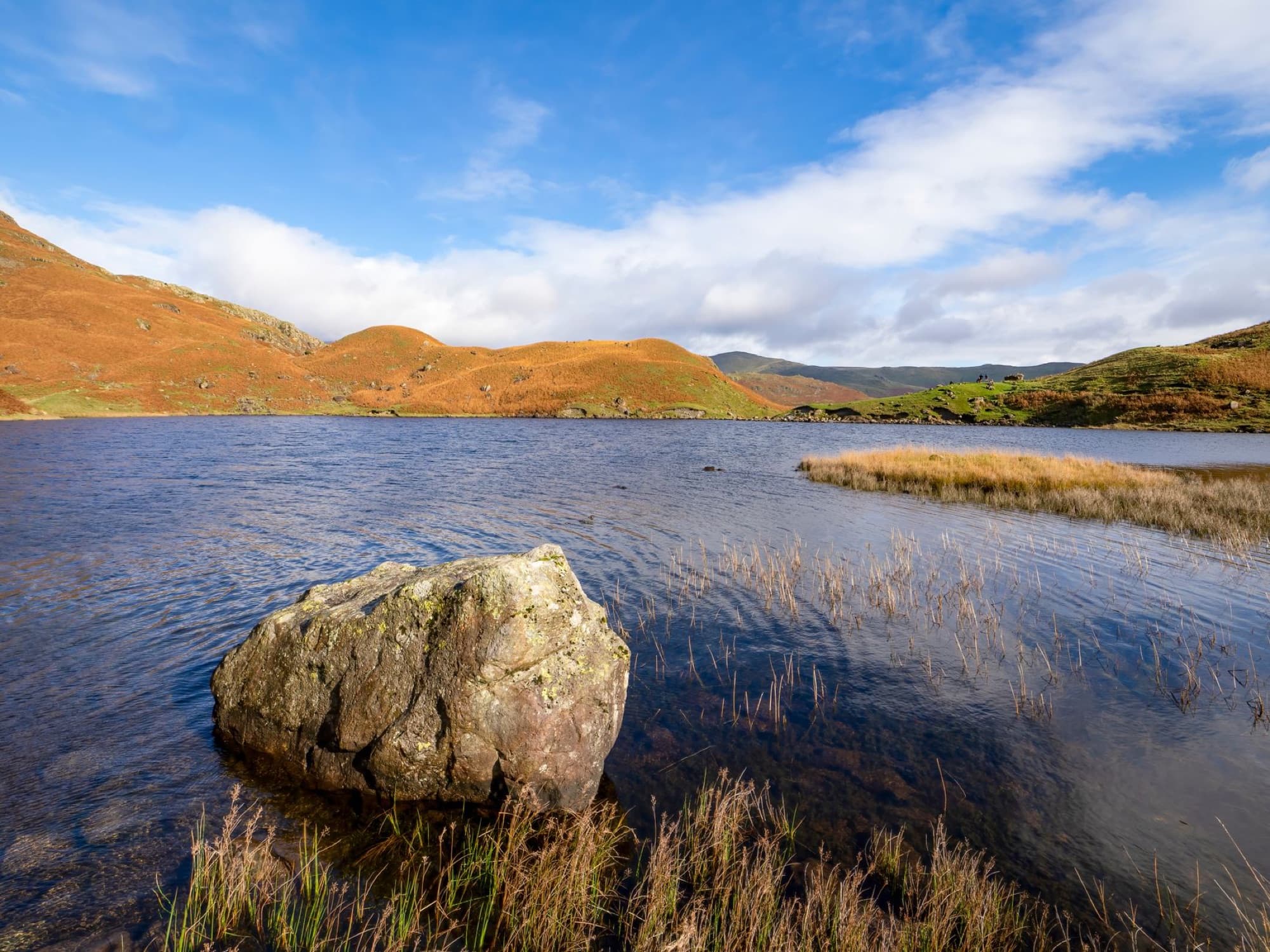 Beautiful landscape of Easedale Tarn with mountains and clear sky in Lake District, UK.