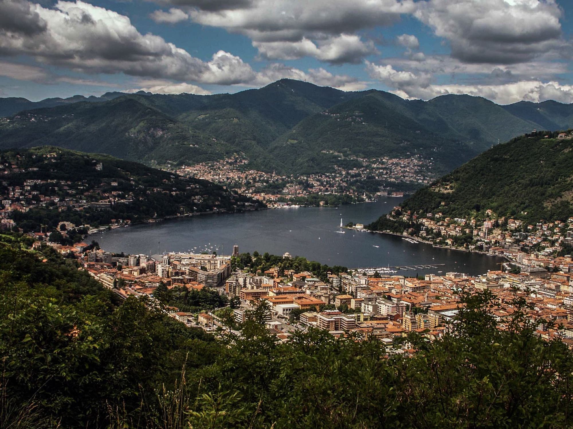 A breathtaking aerial vista of Lake Como nestled in the lush Lombardy mountains.