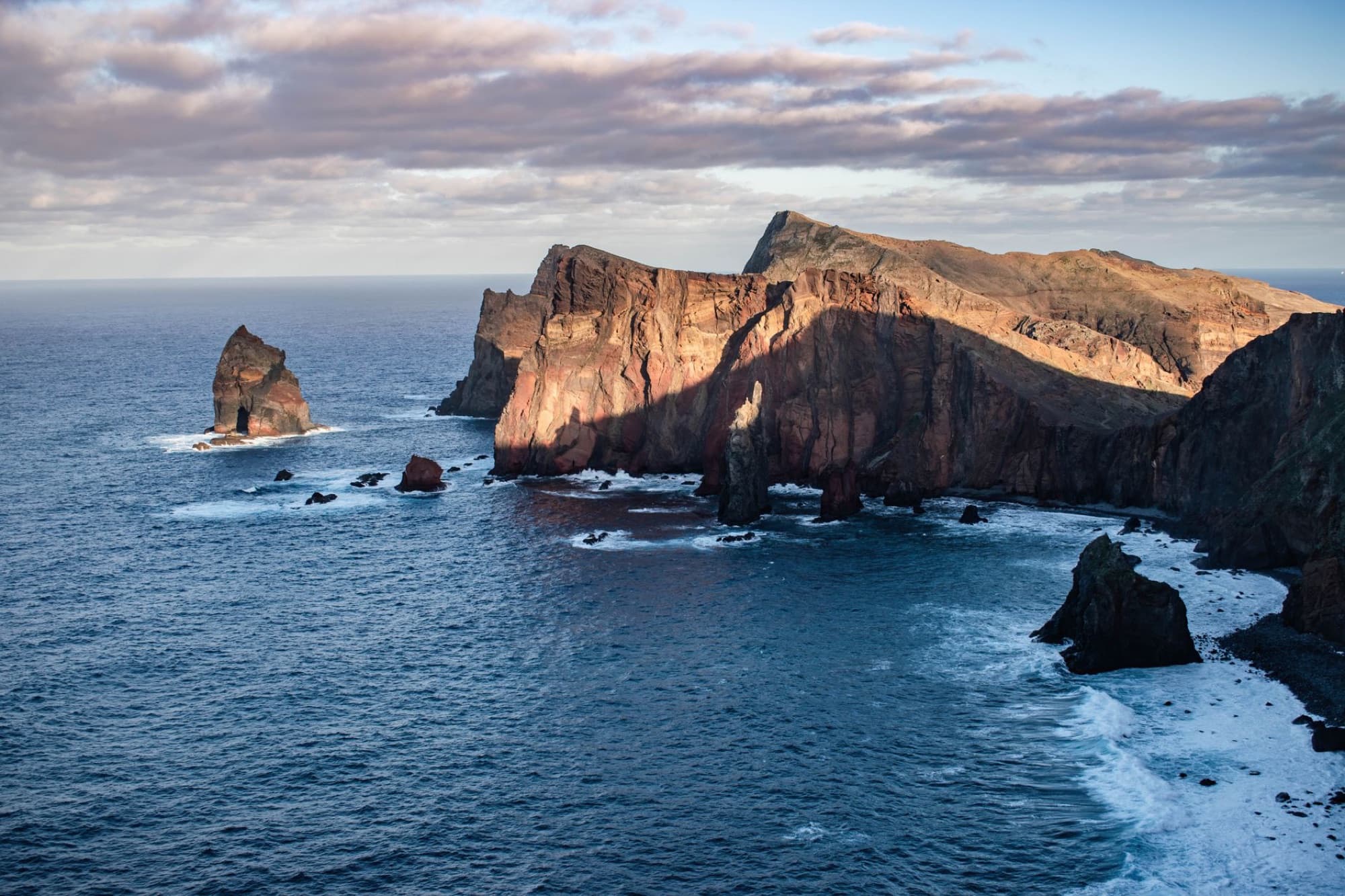 Stunning aerial view of Madeira's rugged cliffs bathed in sunset light.