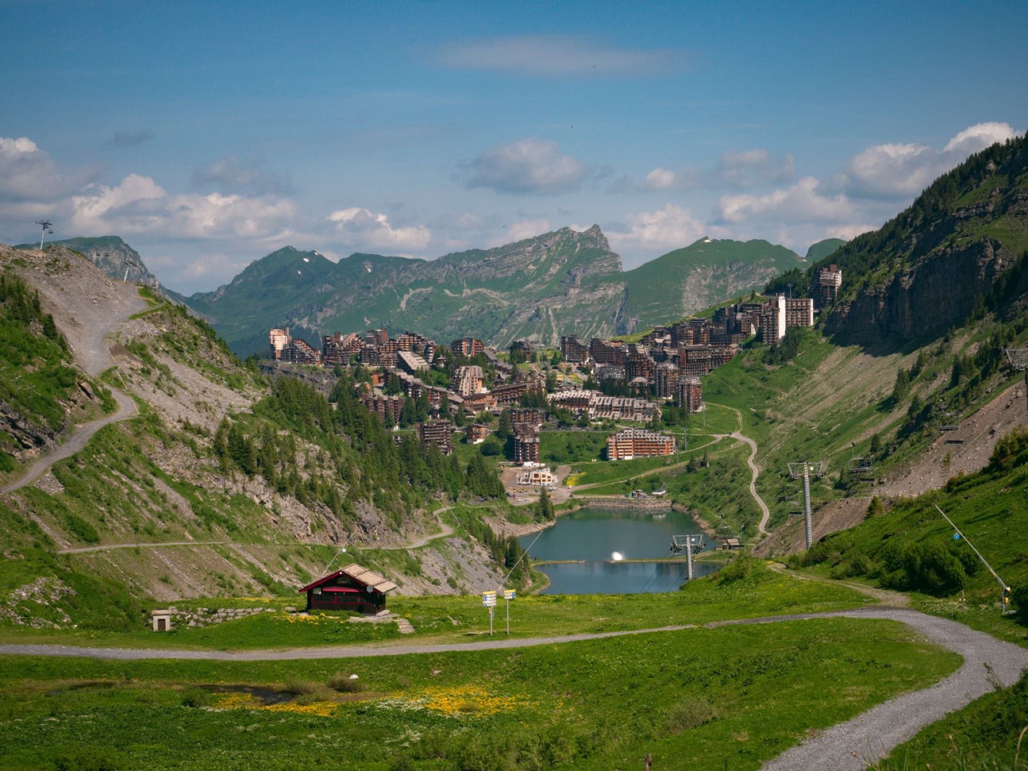 Captivating summer landscape of Morzine, France nestled in Alpine mountains with clear skies.
