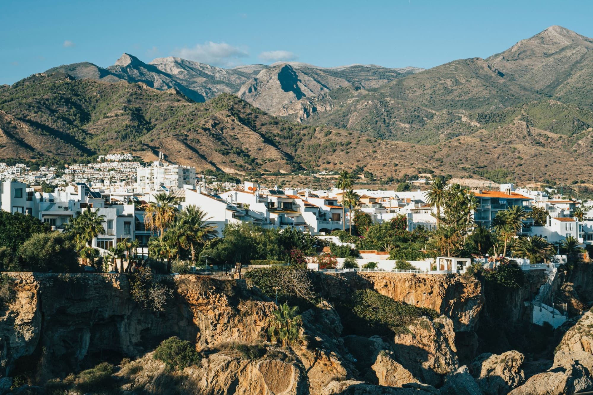 Scenic view of Nerja, Andalusia with white buildings and mountains. Perfect for travel and architecture themes.