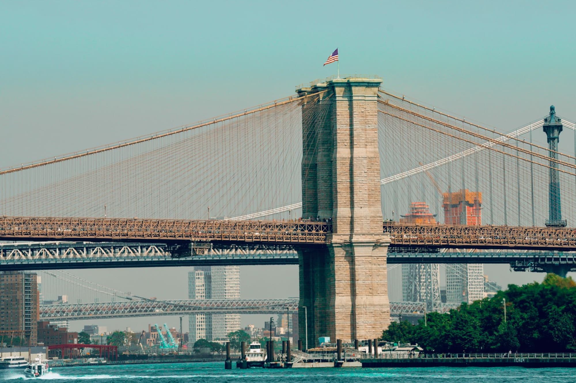 Scenic view of the iconic Brooklyn Bridge with New York City skyline in the background.