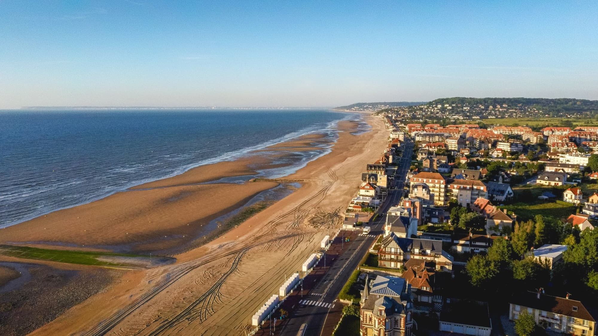 A stunning aerial view of Villers-sur-Mer beach, coastline, and residential area in Normandy, France.