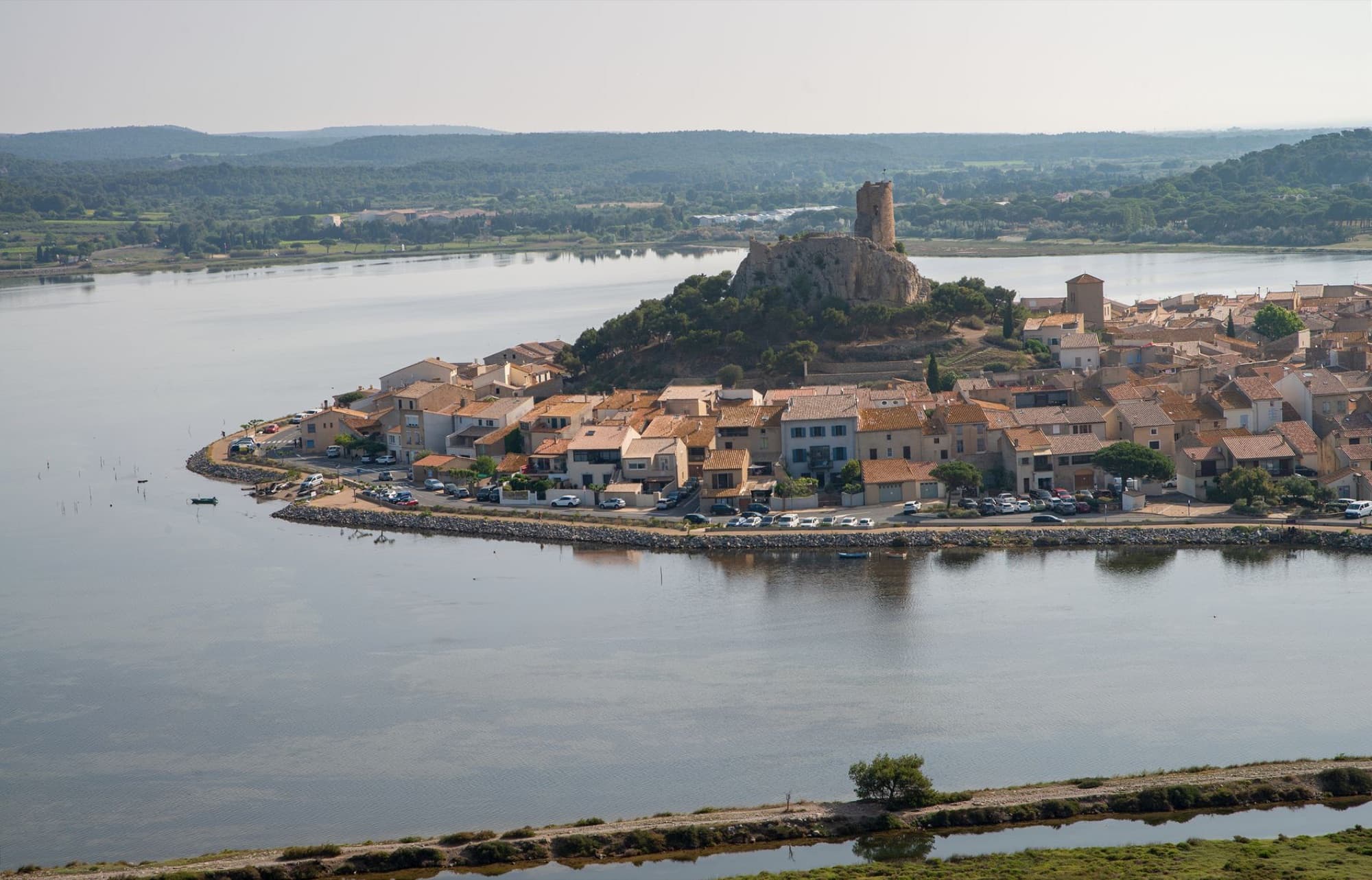 Scenic aerial view of historic Gruissan village by the lake in Occitanie, France.