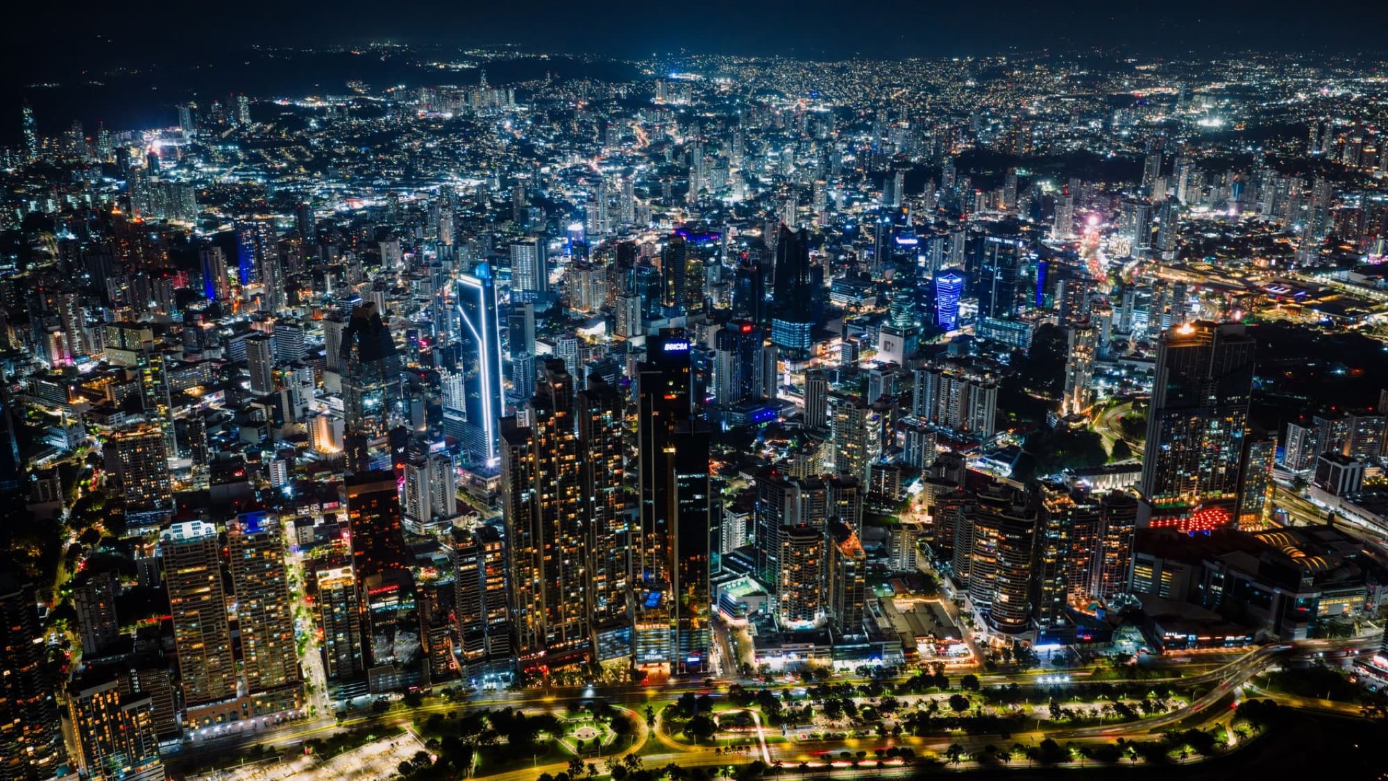 Stunning aerial shot of Panama City's vibrant skyline at night, a bustling urban landscape.