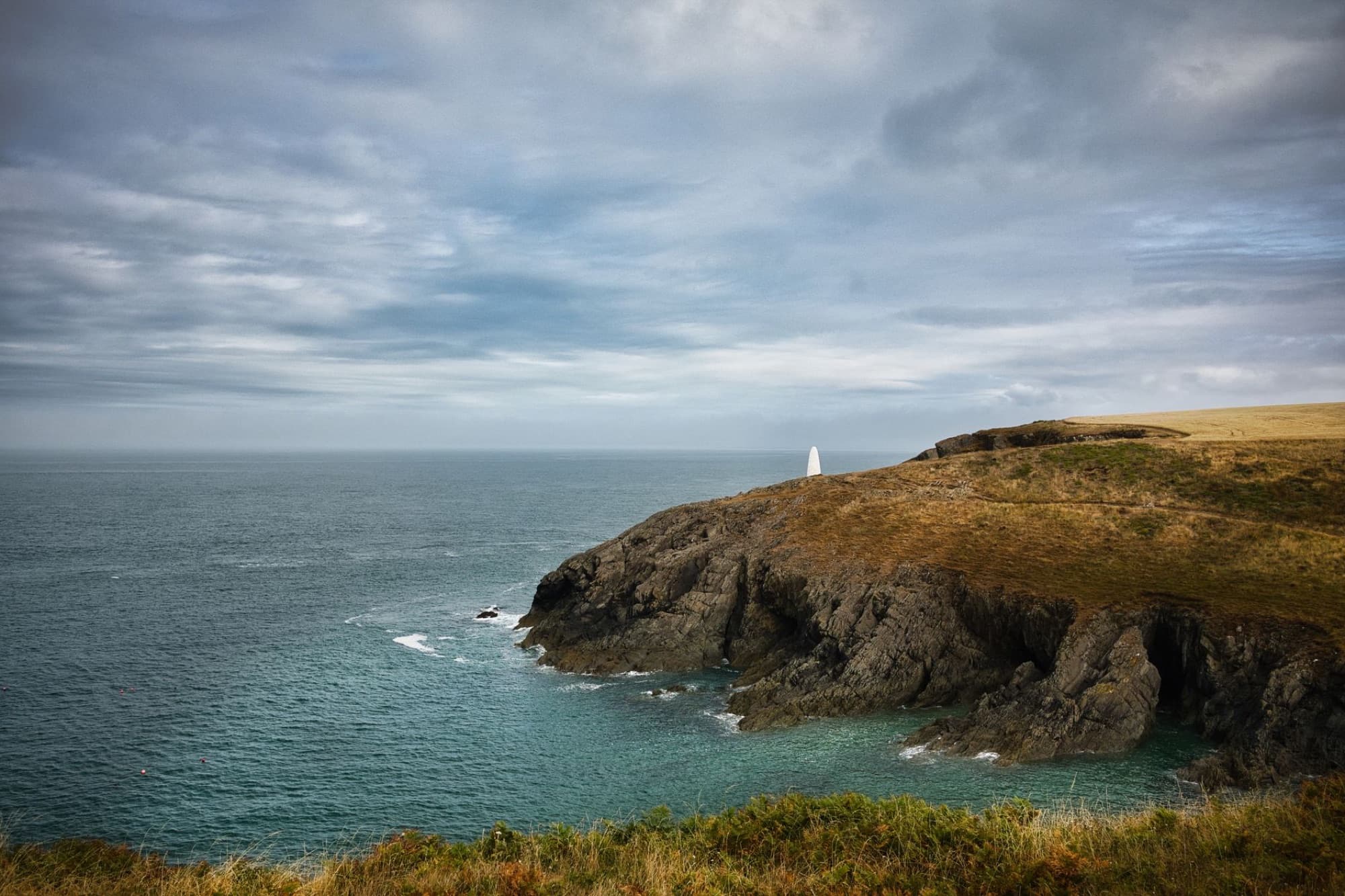 Scenic view of the rugged coastline and lighthouse at St. Ann's Head, Pembrokeshire, Wales, United Kingdom.