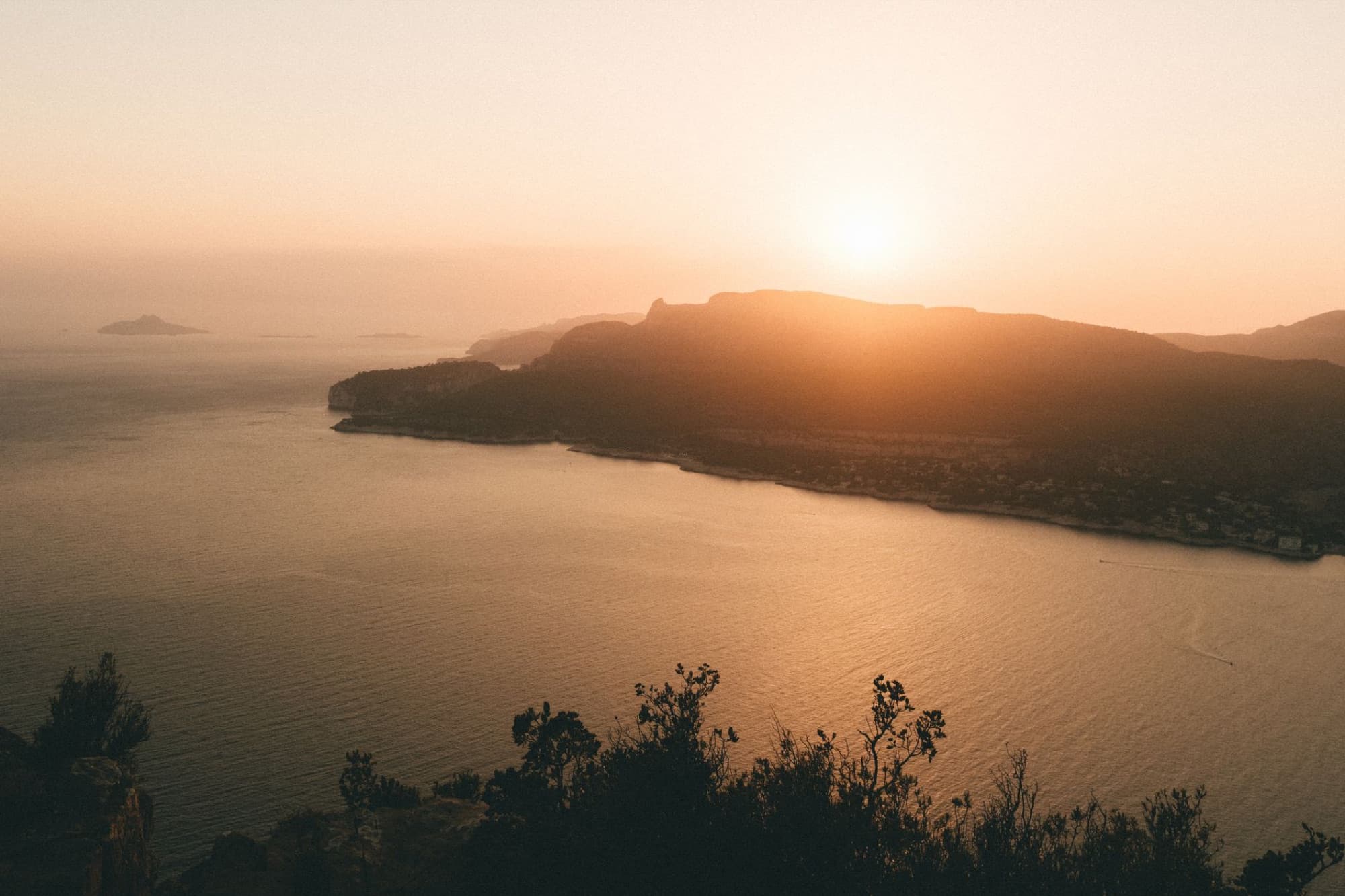 Scenic sunset view over Cassis coastline, Provence, with a warm, serene atmosphere.