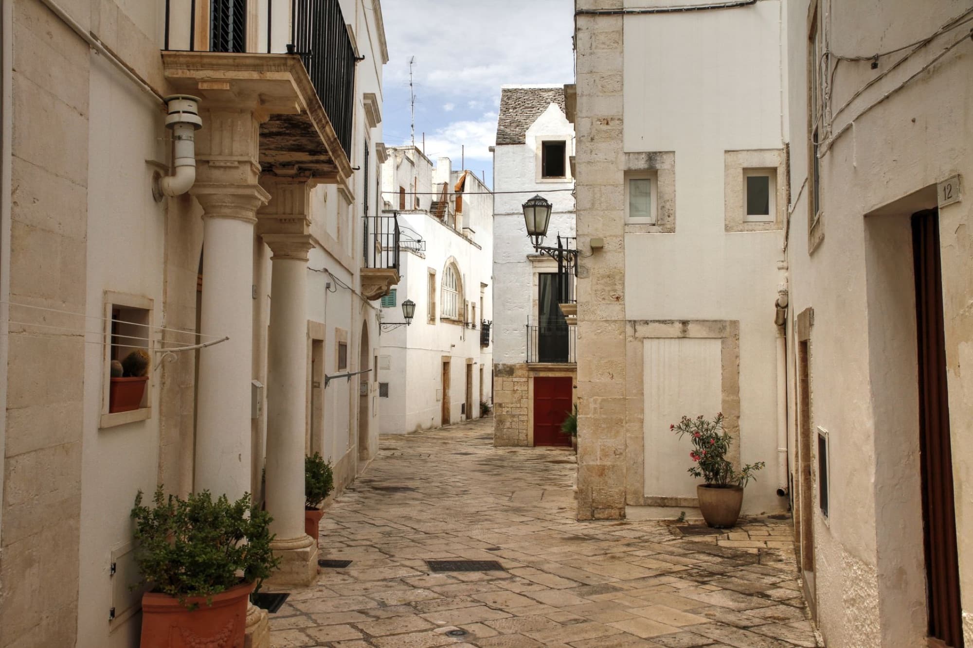Explore the picturesque alleys and historic architecture of Locorotondo in Puglia, Italy.