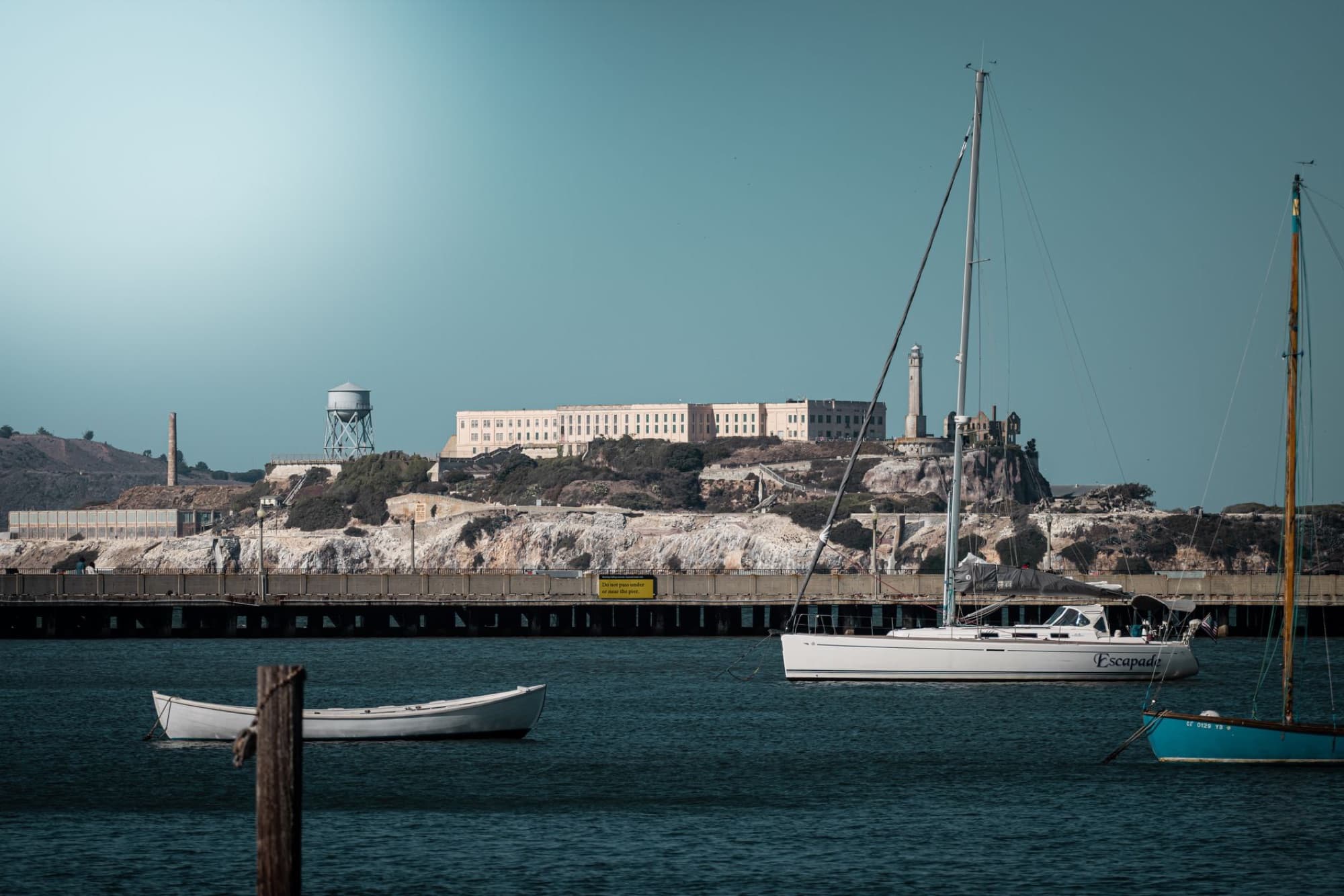 Scenic view of Alcatraz Island and surrounding yachts in San Francisco Bay on a clear day.