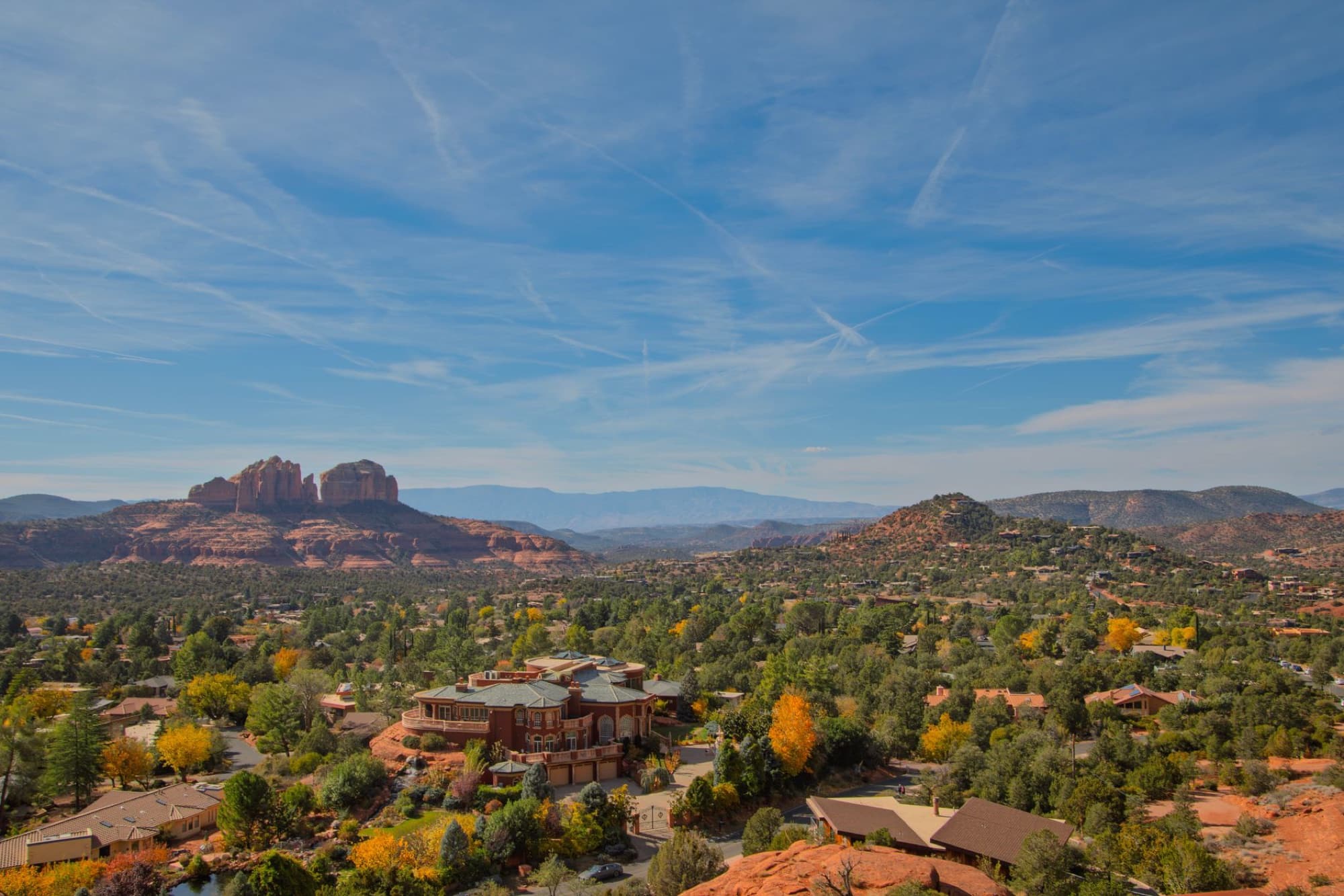 A breathtaking aerial view of Sedona, Arizona with vibrant red rocks and lush greenery.