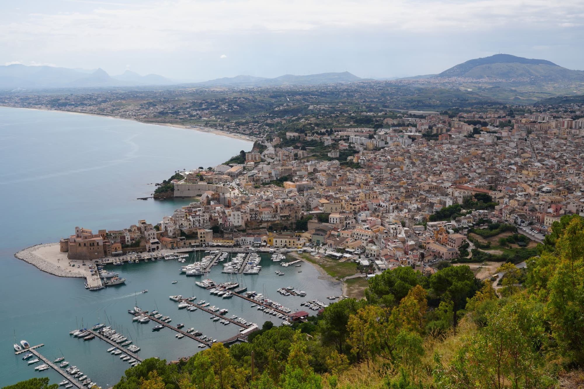 Scenic aerial photo of Castellammare del Golfo in Sicily, showcasing the beautiful harbor and coastline.