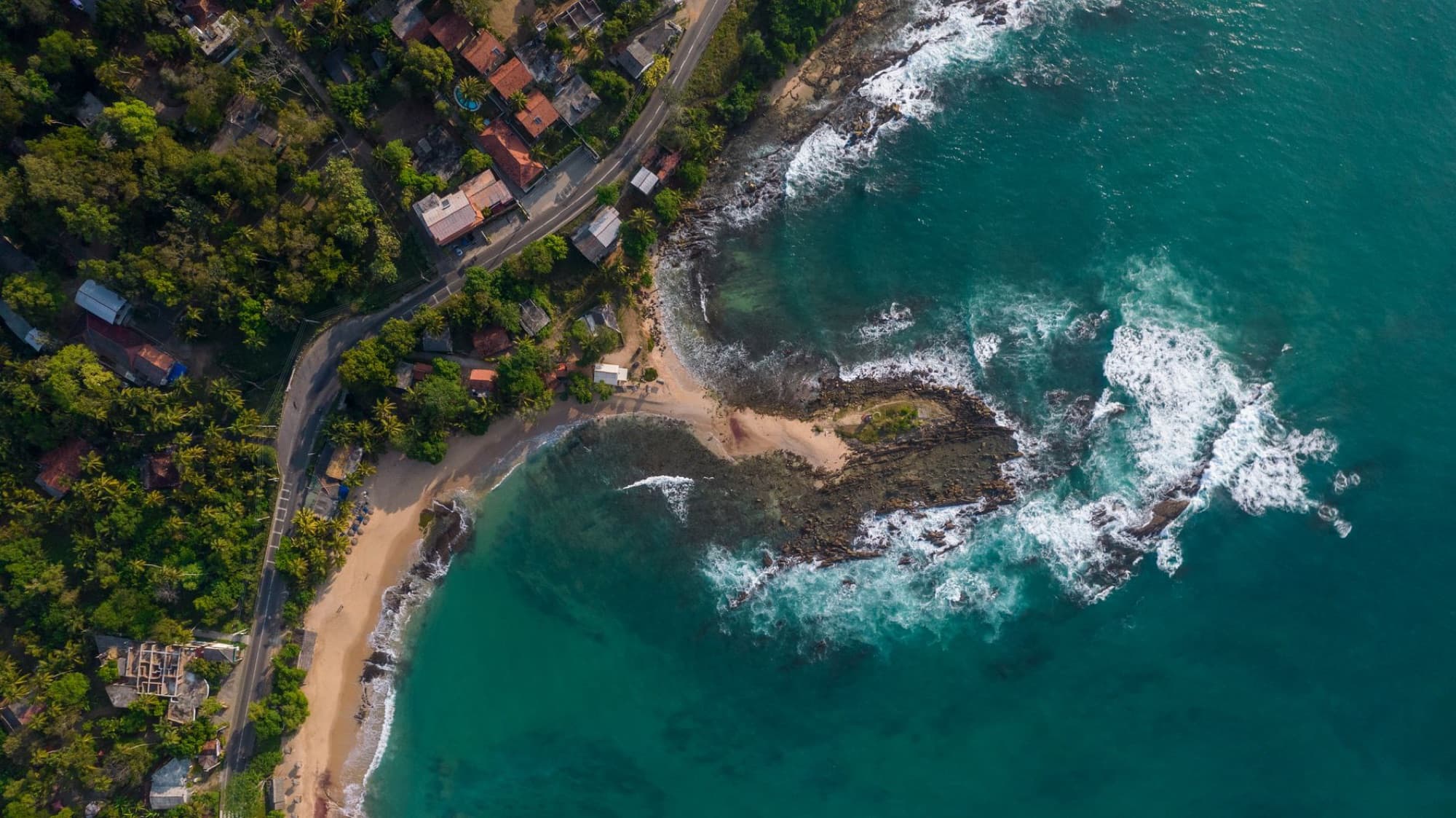 Stunning aerial view of Thangalla Beach, showcasing the pristine coastline and vibrant ocean waters in Sri Lanka.