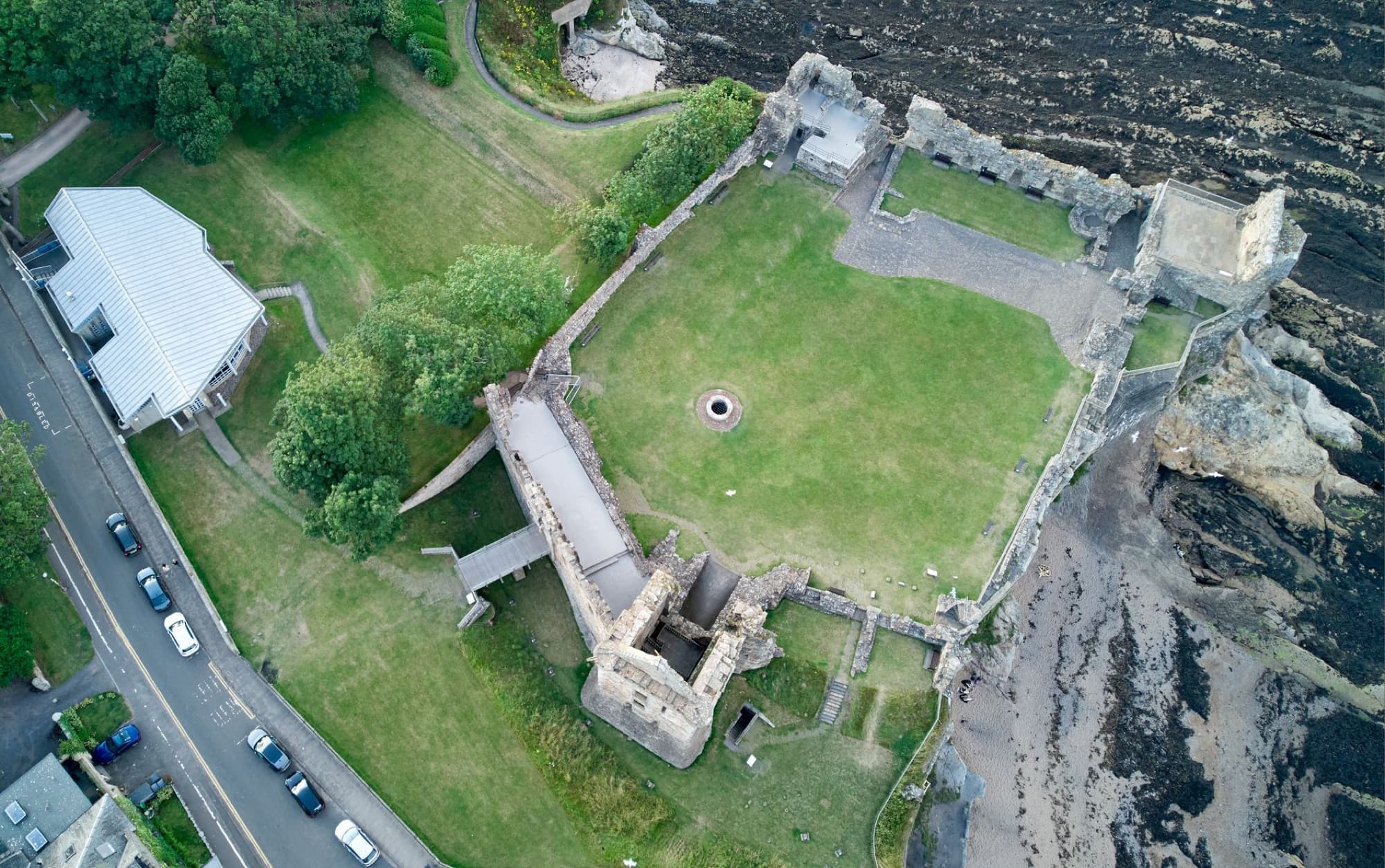 Aerial view of historic St Andrews Castle ruins in Scotland's beautiful landscape.