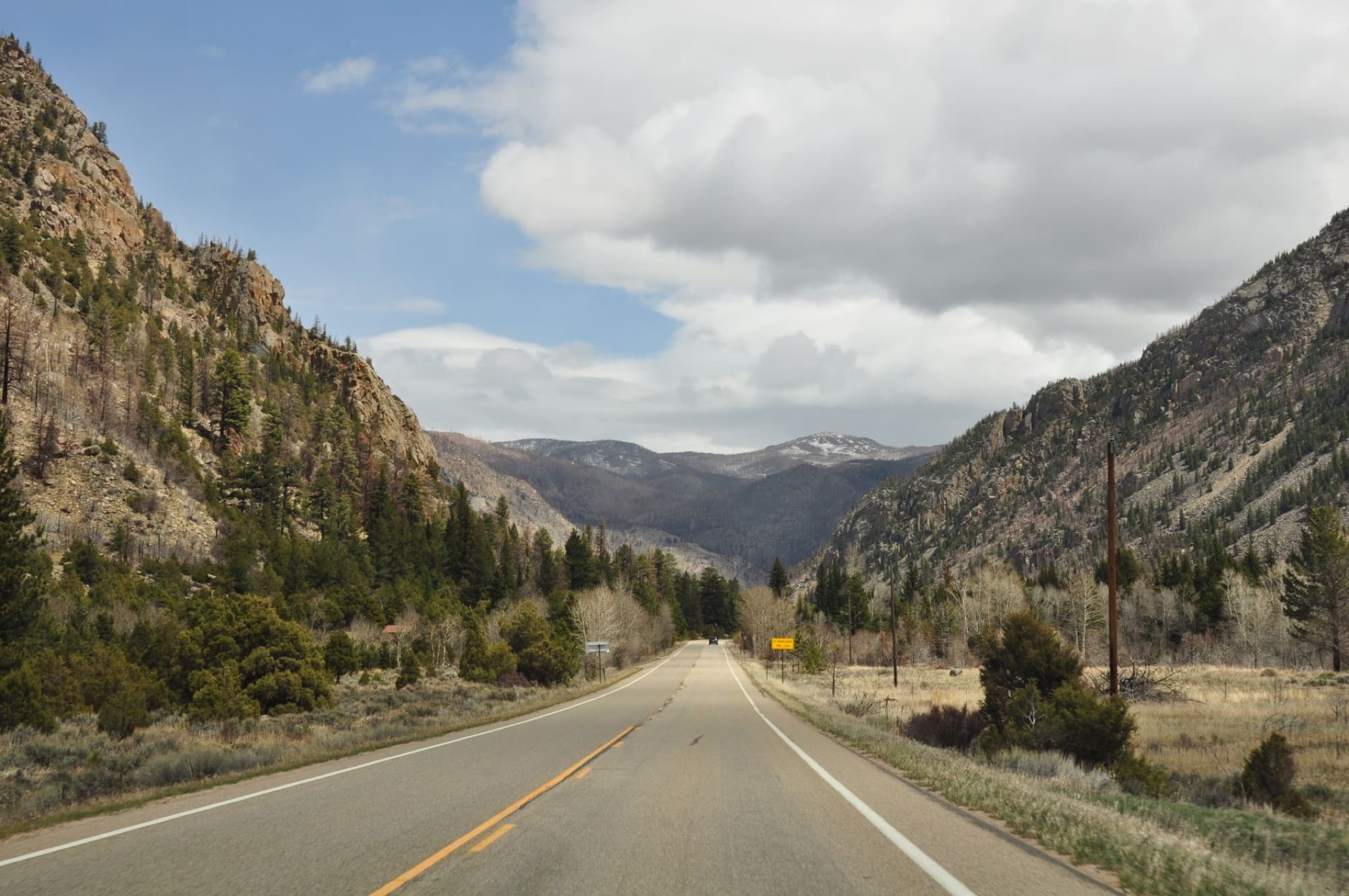 Explore the scenic mountain road in Steamboat Springs, Colorado, capturing rural tranquility.