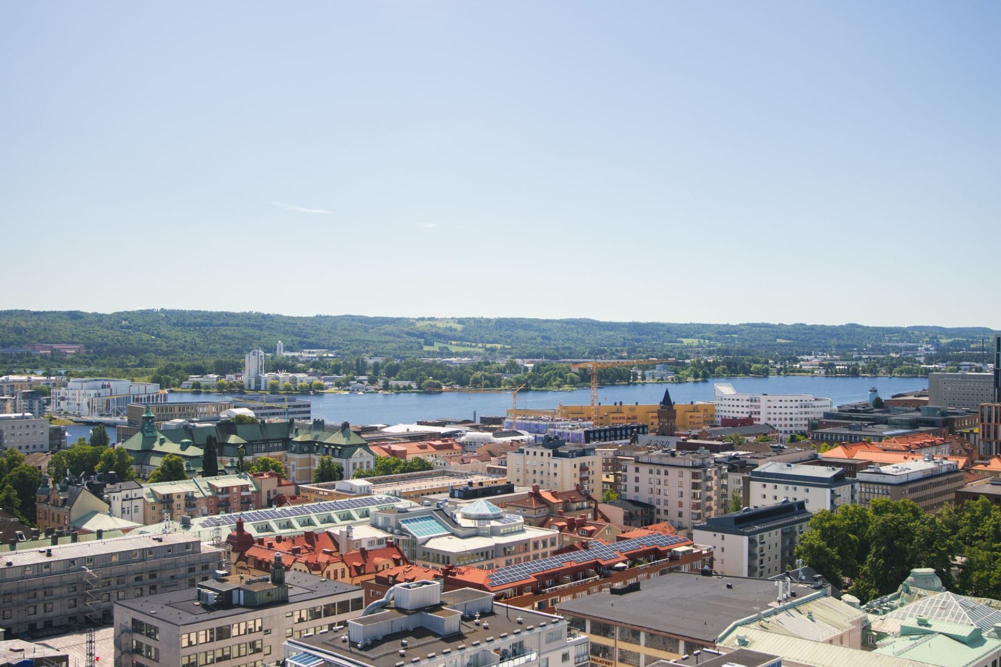 Vibrant aerial view of Jönköping, Sweden, featuring Lake Vättern and colorful buildings on a sunny day.