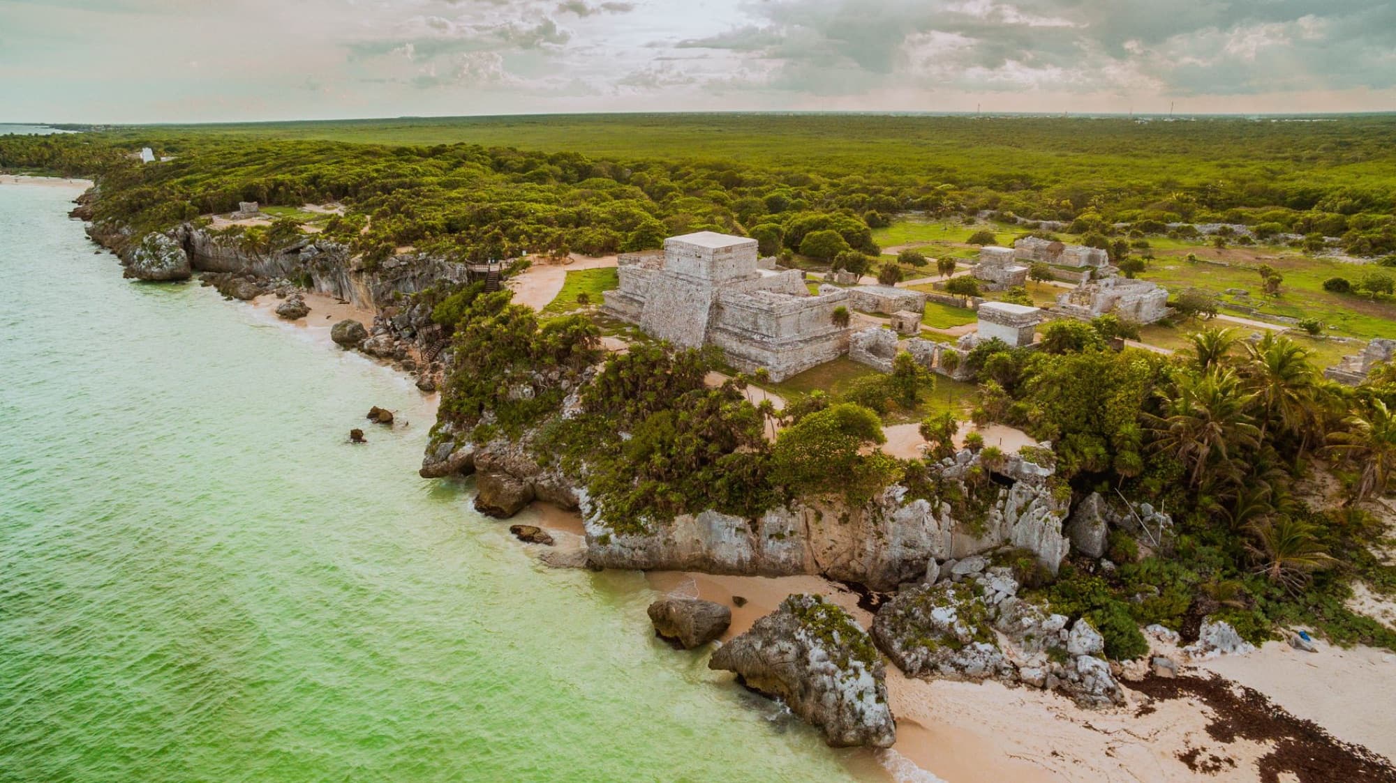 Stunning aerial view of the ancient Tulum Mayan ruins overlooking the turquoise Caribbean Sea in Mexico.