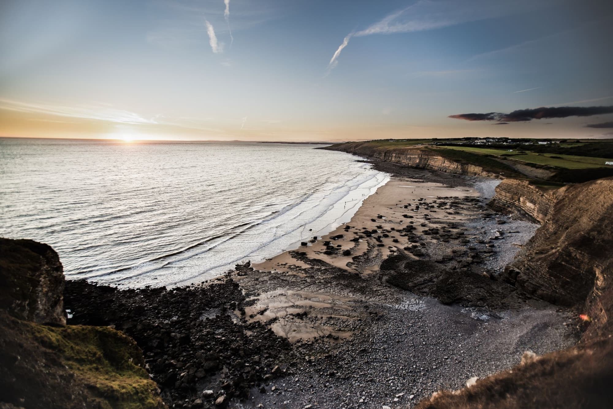 Breathtaking view of Southerndown Beach cliffs and coast at sunset, capturing the serene seascape in Wales.