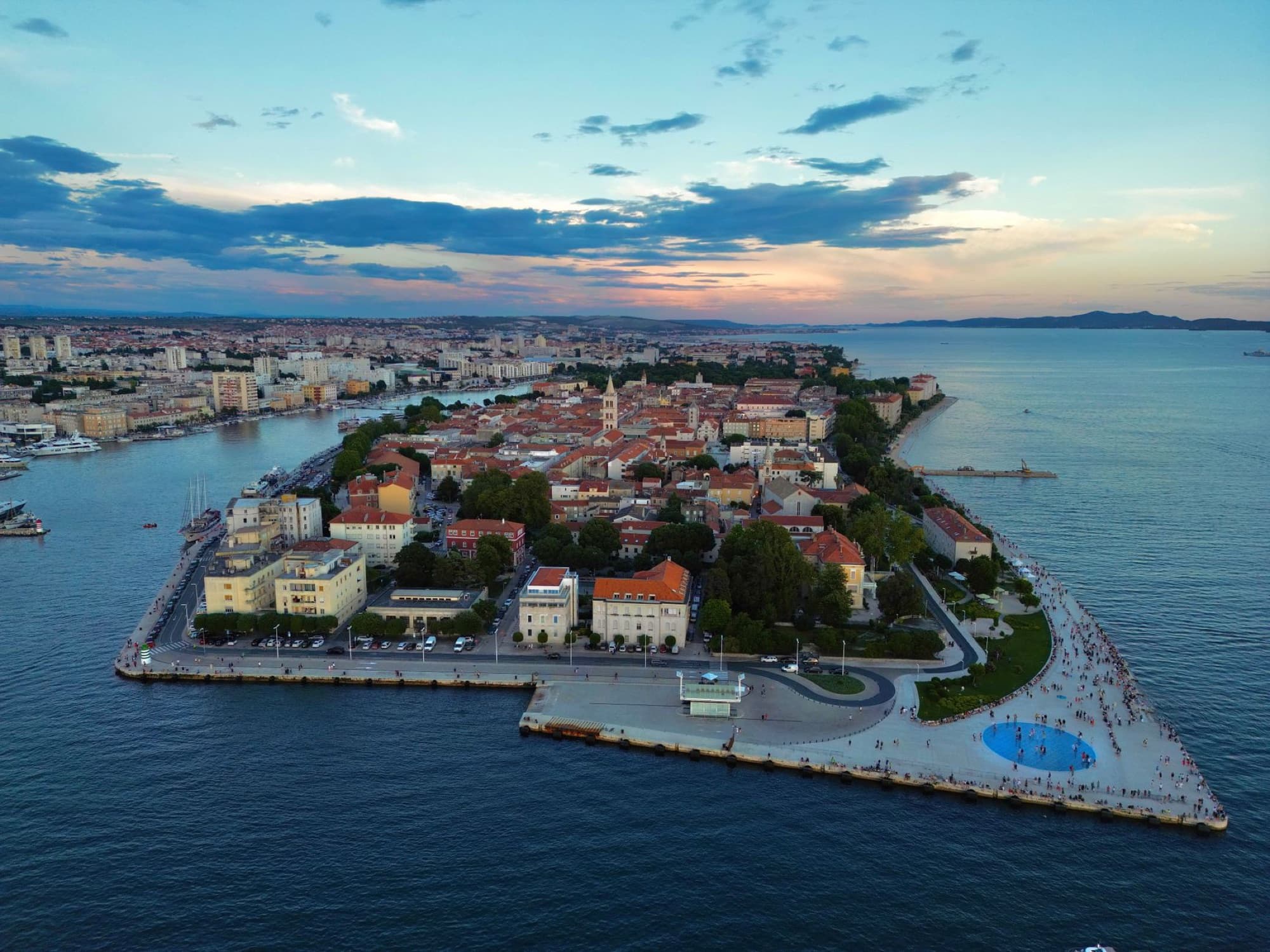 Stunning aerial image of Zadar, Croatia, capturing cityscape and coastline at sunset.